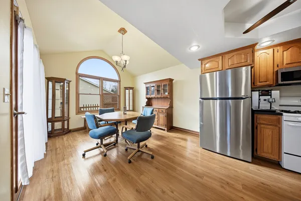 a dining room with furniture a window and wooden floor
