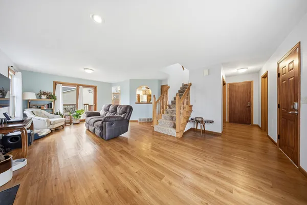 a living room with furniture and a wooden floor