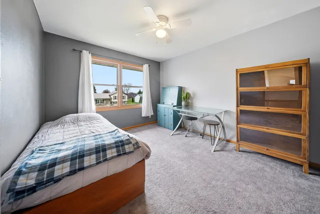 a bedroom with a bed and a table