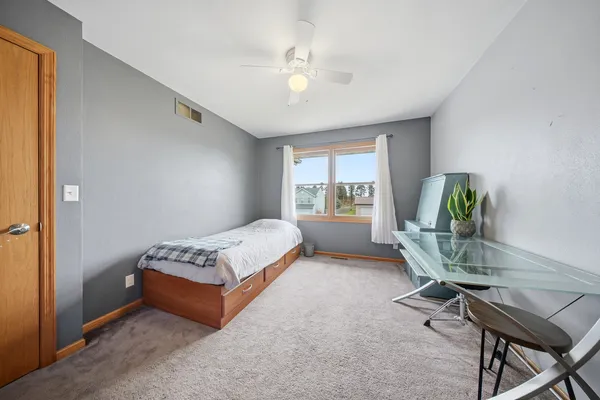 a bedroom with a bed and a window