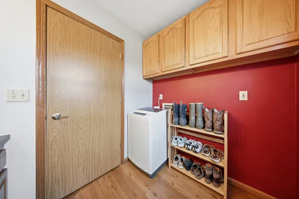 a view of a room with wooden floor and cabinet