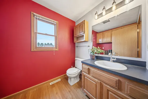 a bathroom with a sink vanity mirror and toilet