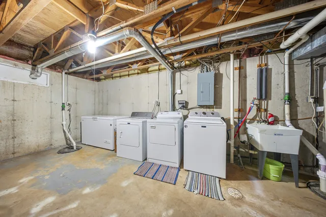 a view of a garage with white cabinets