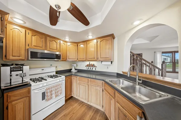 a kitchen with stainless steel appliances granite countertop a sink and cabinets