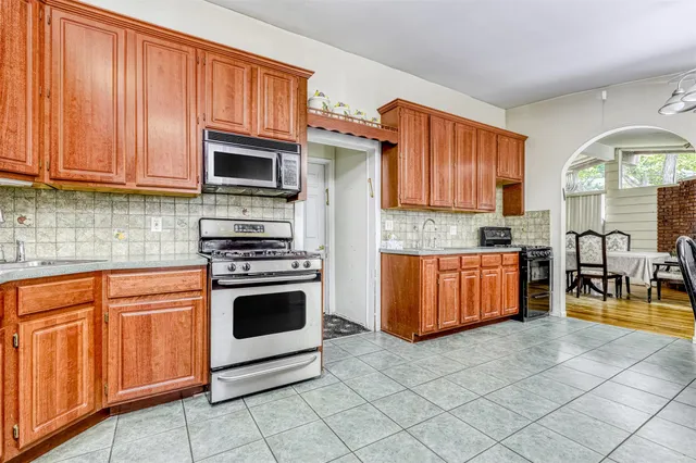 a kitchen with stainless steel appliances granite countertop a stove top oven a sink dishwasher and cabinets