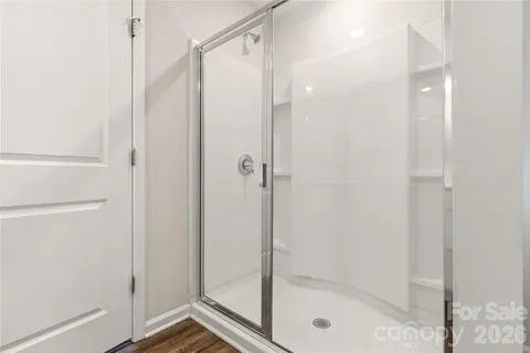 a bathroom with a glass shower door