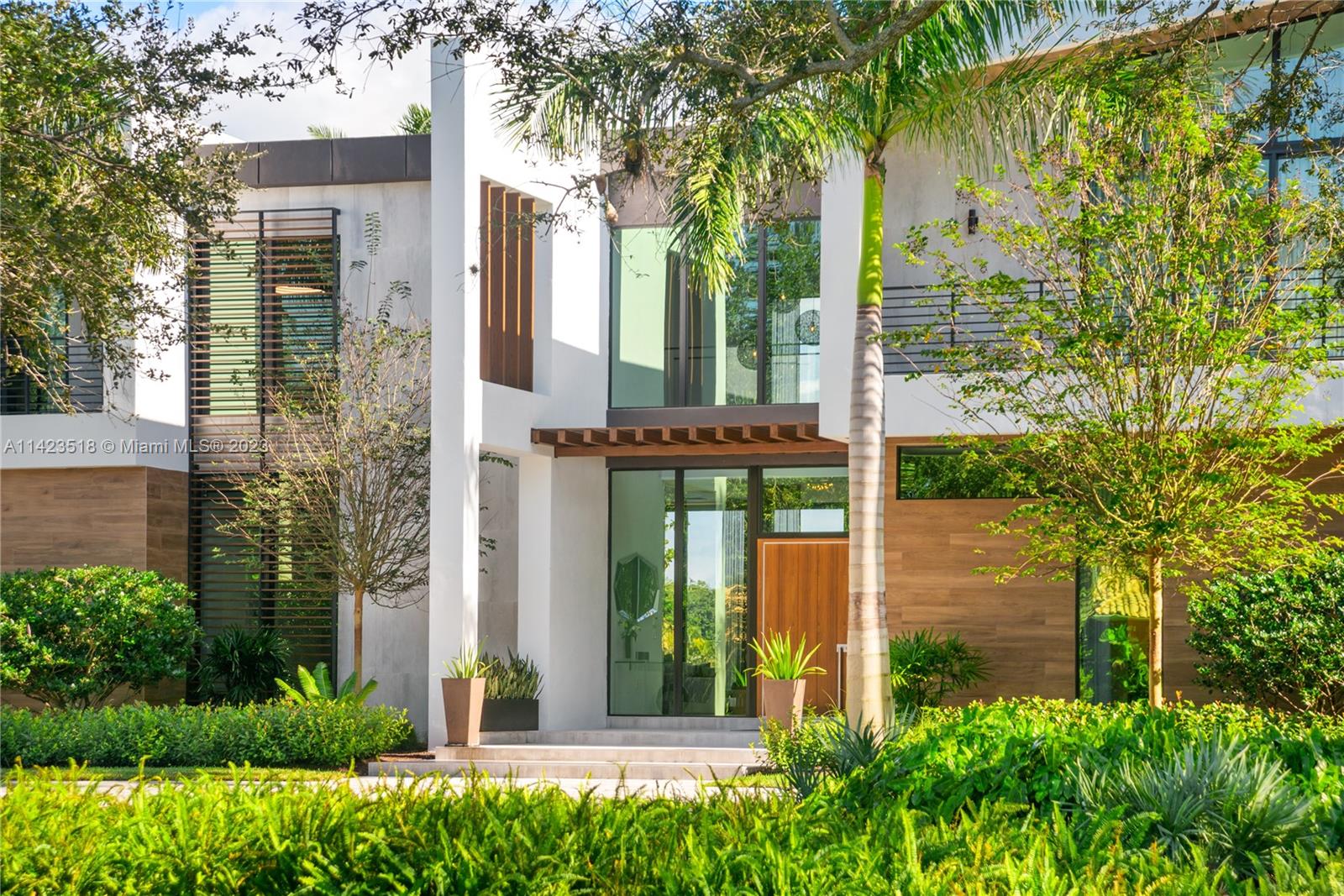 2690 Hackney Road Weston, FL 33331 - Photo 11 of 88 a front view of a house with a garden