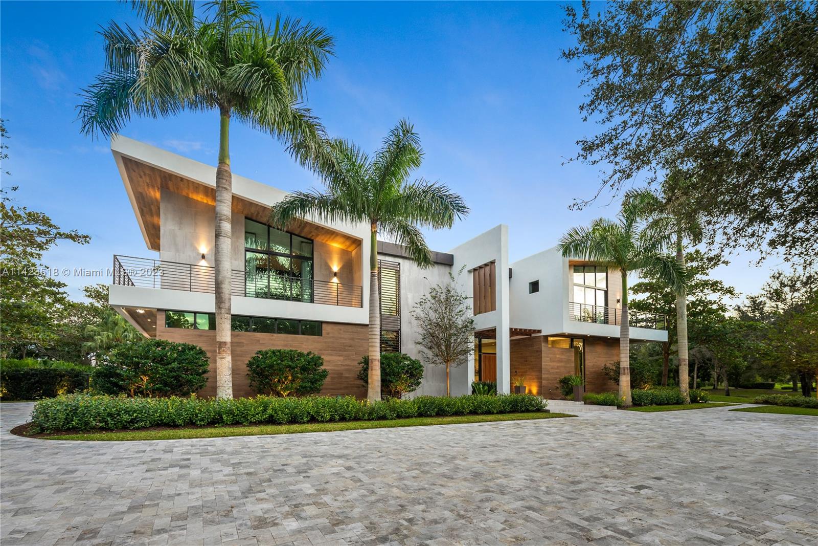 2690 Hackney Road Weston, FL 33331 - Photo 12 of 88 a view of a white house with a big yard and palm trees