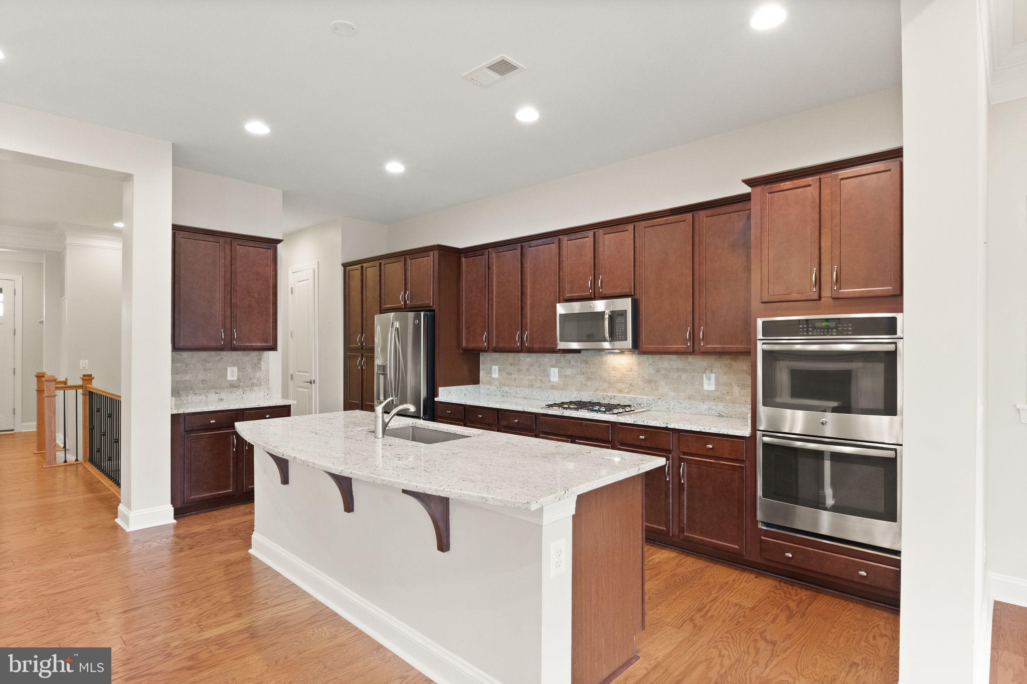 103 Cloak Lane White Post, VA 22663 - Photo 24 of 98 a kitchen with stainless steel appliances kitchen island granite countertop a refrigerator and a stove top oven