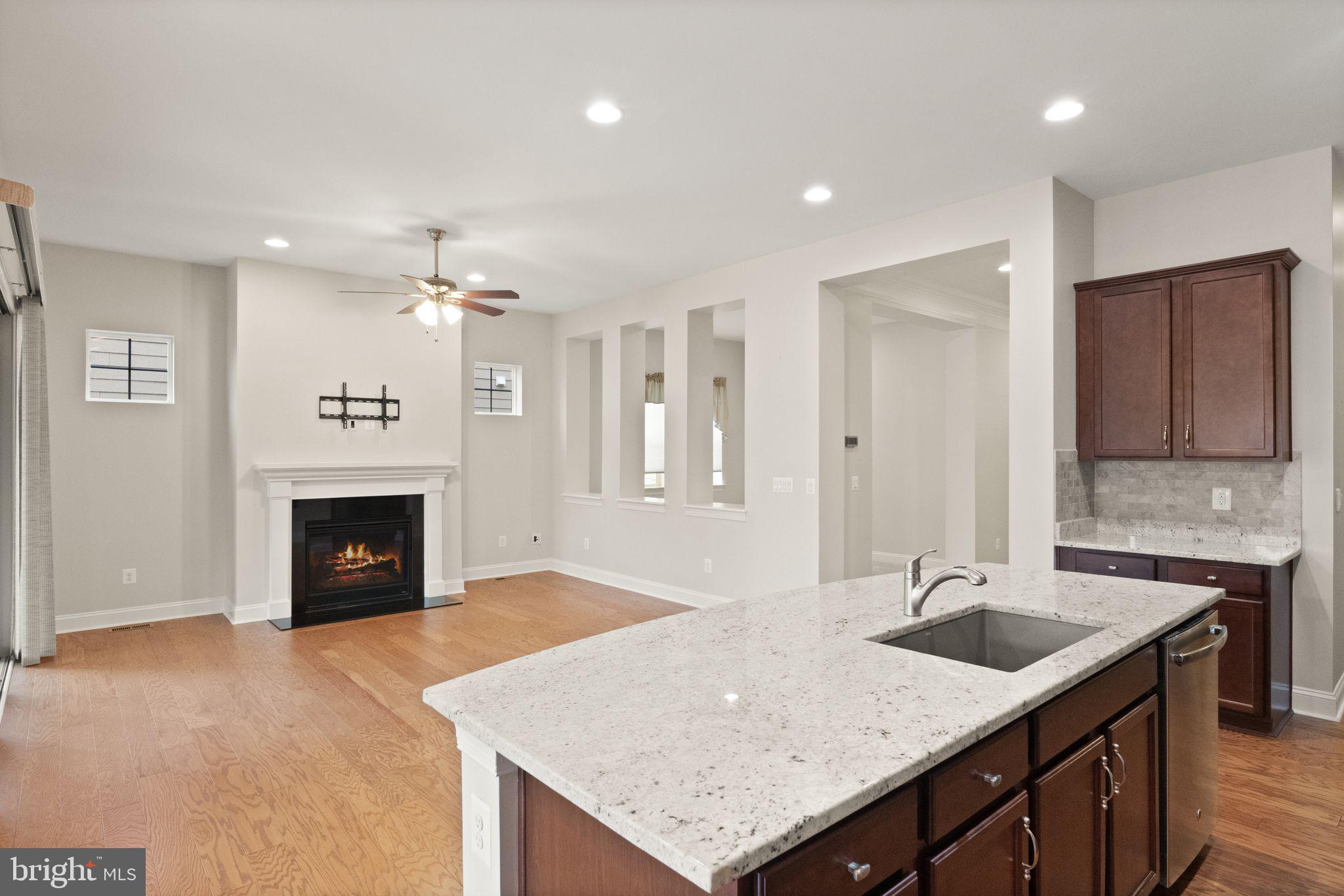 103 Cloak Lane White Post, VA 22663 - Photo 27 of 98 a kitchen with a sink a fireplace and cabinets