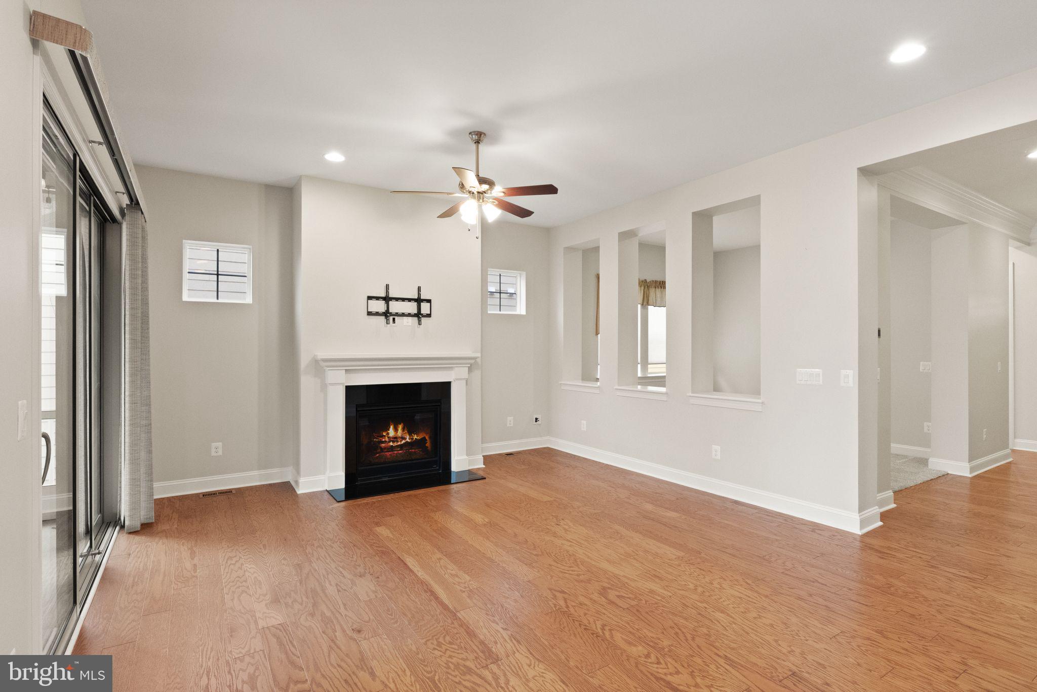 103 Cloak Lane White Post, VA 22663 - Photo 30 of 98 a view of a livingroom with a fireplace a ceiling fan and windows