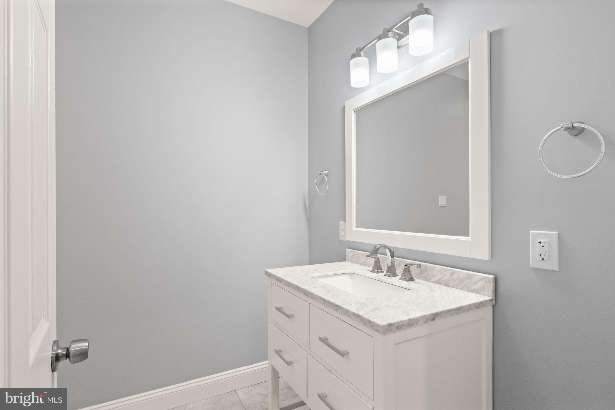 103 Cloak Lane White Post, VA 22663 - Photo 61 of 98 a bathroom with a granite countertop sink and a mirror