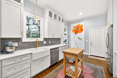 a kitchen with a sink cabinets and window