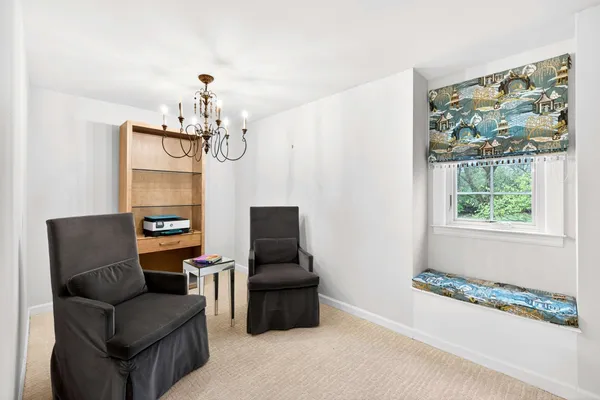 a living room with furniture and a chandelier