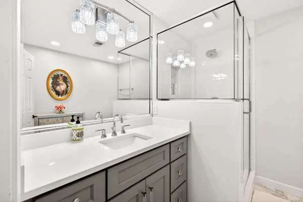 a bathroom with a sink vanity and a mirror
