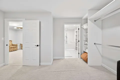 a view of a livingroom with wooden floor and white doors