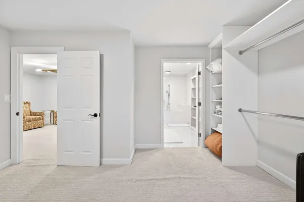 a view of a livingroom with wooden floor and white doors