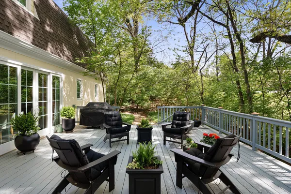 a view of a balcony with chairs and a potted plant
