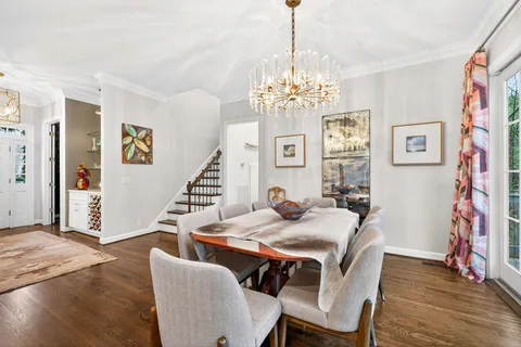 a view of a dining room with furniture wooden floor and chandelier