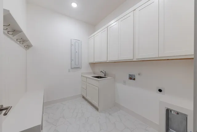 a kitchen with stainless steel appliances granite countertop a sink and cabinets with wooden floor