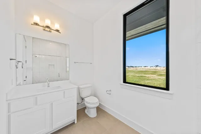a bathroom with a toilet sink and mirror