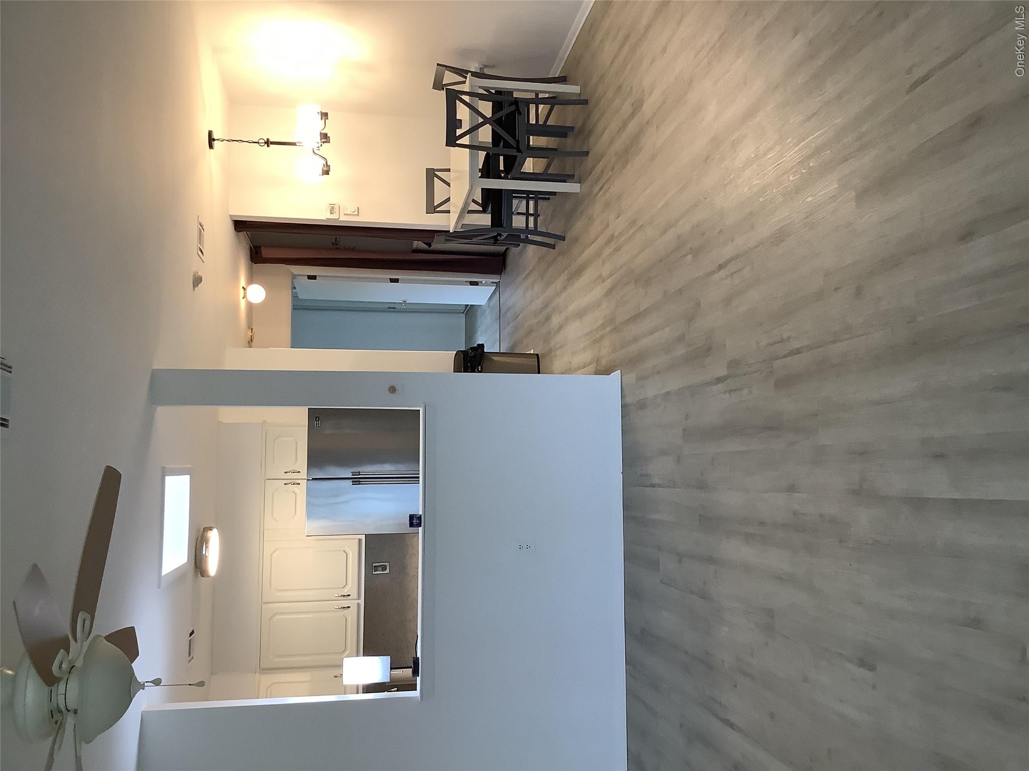 406 Woodbridge Drive, Unit B Ridge, NY 11961 - Photo 3 of 5 a view of dining room with furniture and wooden floor