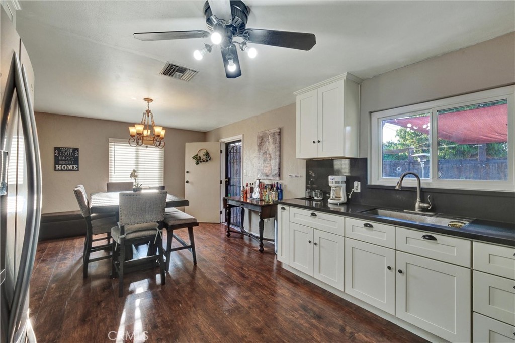 2435 Burkett Road El Monte, CA 91732 - Photo 16 of 52 a kitchen with granite countertop lots of counter space dining table and stainless steel appliances