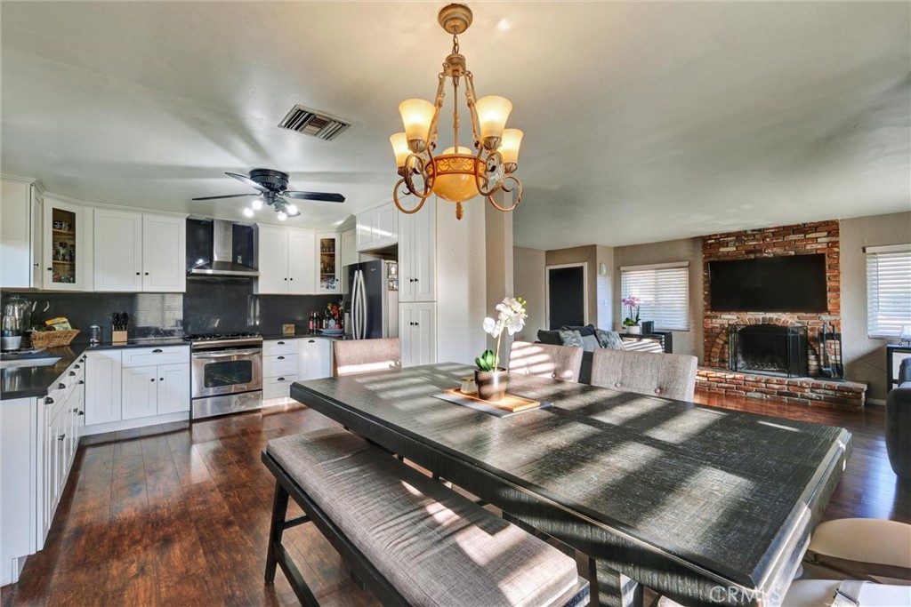 2435 Burkett Road El Monte, CA 91732 - Photo 17 of 52 a view of a dining room with furniture a chandelier and wooden floor