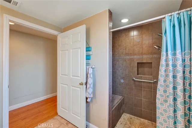 a bathroom with a shower and a glass door