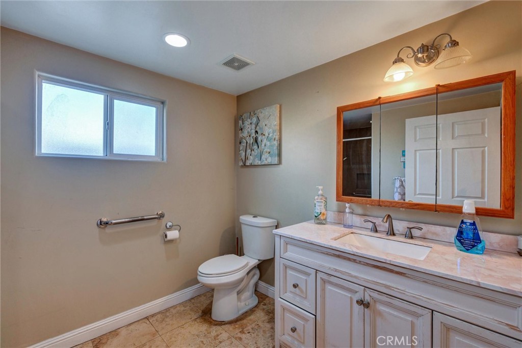 2435 Burkett Road El Monte, CA 91732 - Photo 27 of 52 a bathroom with a sink a toilet and mirror