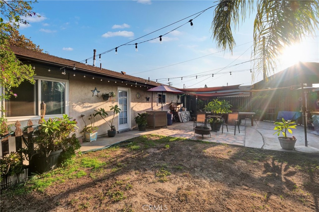 2435 Burkett Road El Monte, CA 91732 - Photo 5 of 52 a view of a patio with table and chairs potted plants and palm trees
