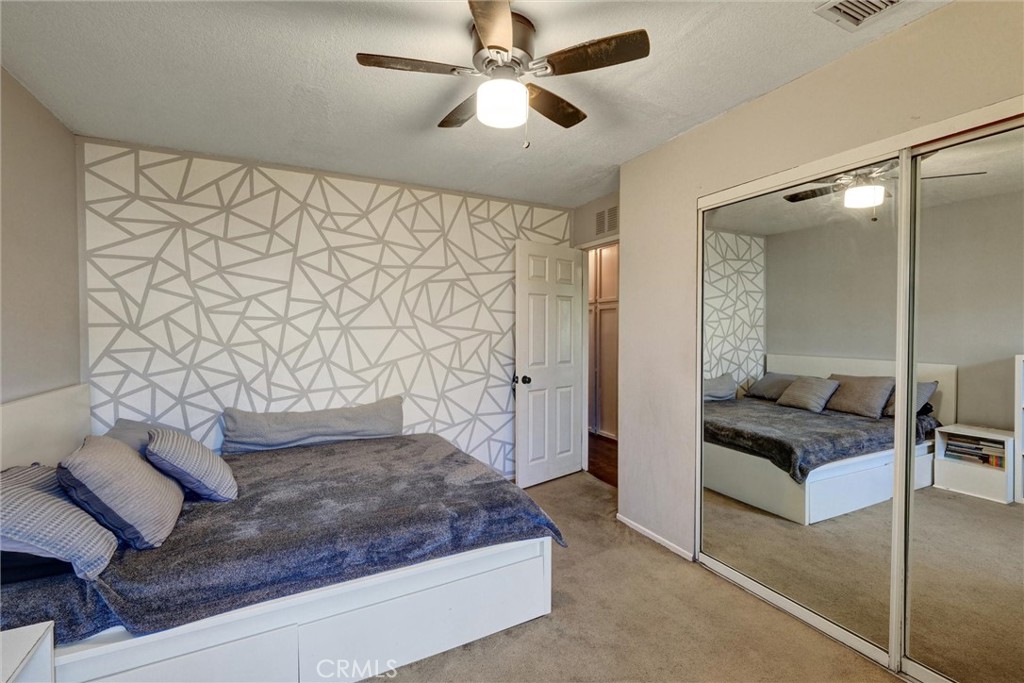 2435 Burkett Road El Monte, CA 91732 - Photo 8 of 52 a bedroom with a bed and a chandelier