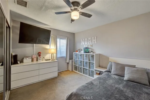 a room with a bed furniture and a flat screen tv