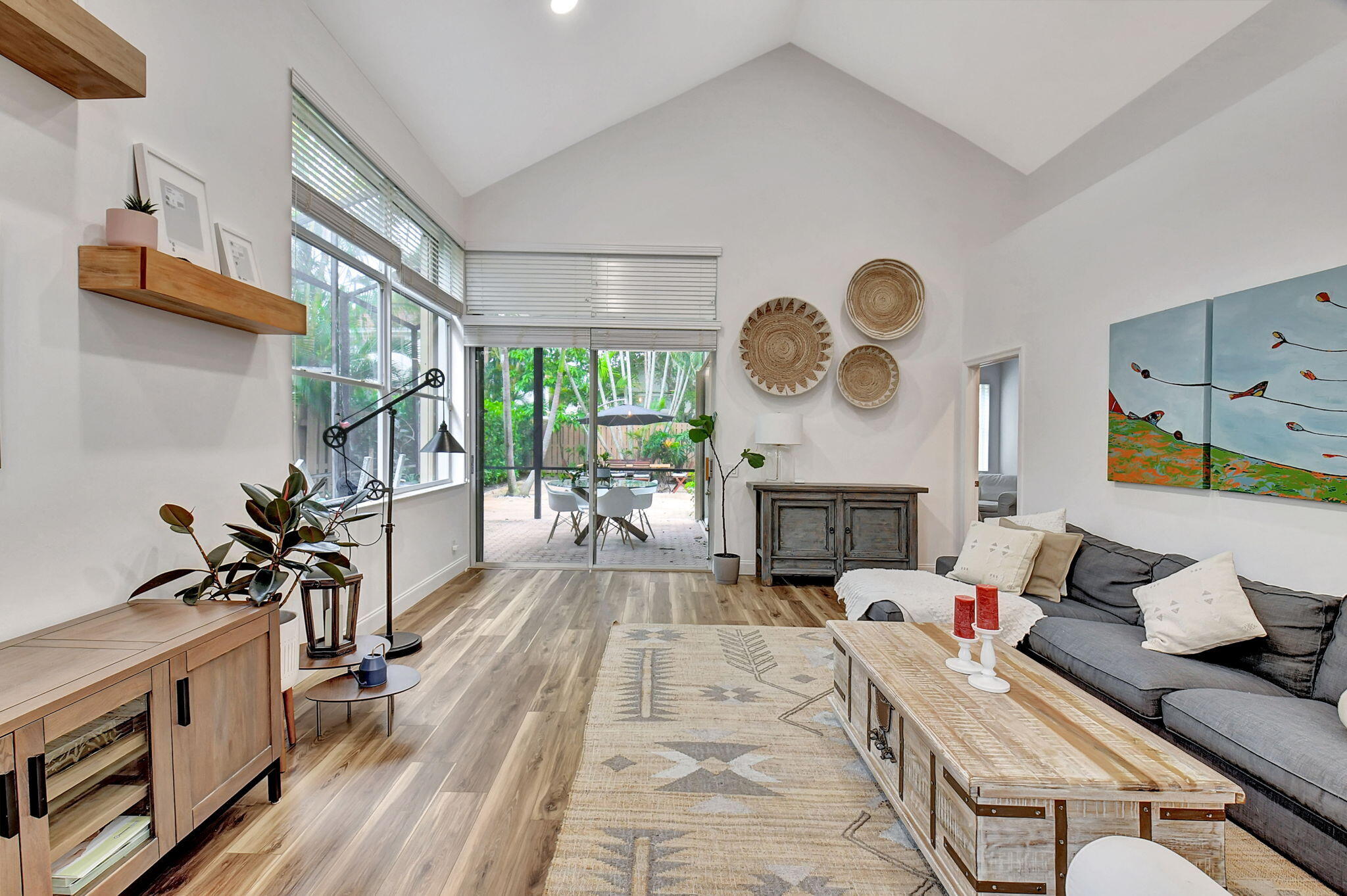 6623 Northwest 25th Avenue Boca Raton, FL 33496 - Photo 15 of 37 a living room with furniture a fireplace and a floor to ceiling window