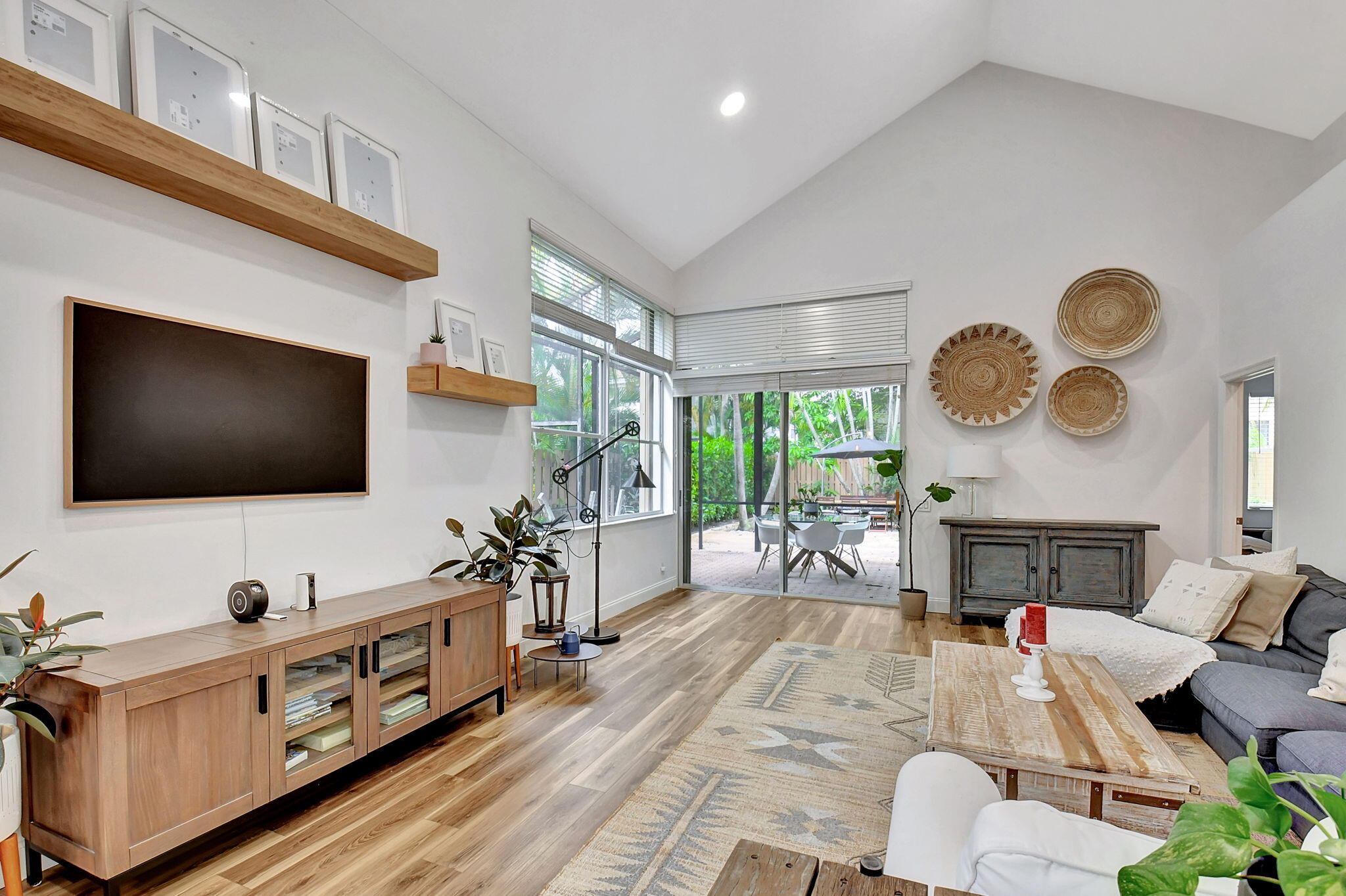 6623 Northwest 25th Avenue Boca Raton, FL 33496 - Photo 16 of 37 a living room with furniture and a flat screen tv