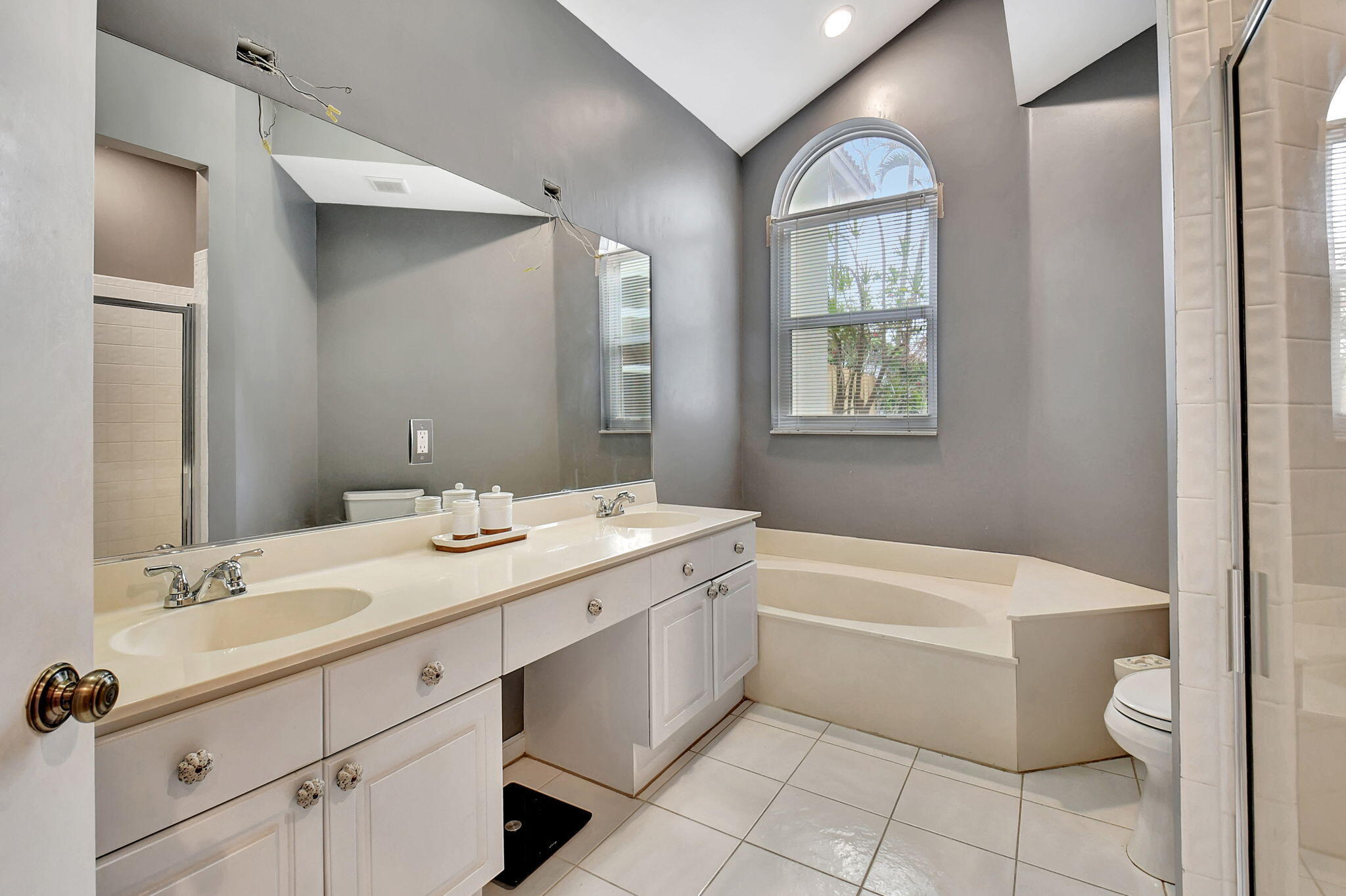 6623 Northwest 25th Avenue Boca Raton, FL 33496 - Photo 18 of 37 a bathroom with a toilet sink and mirror