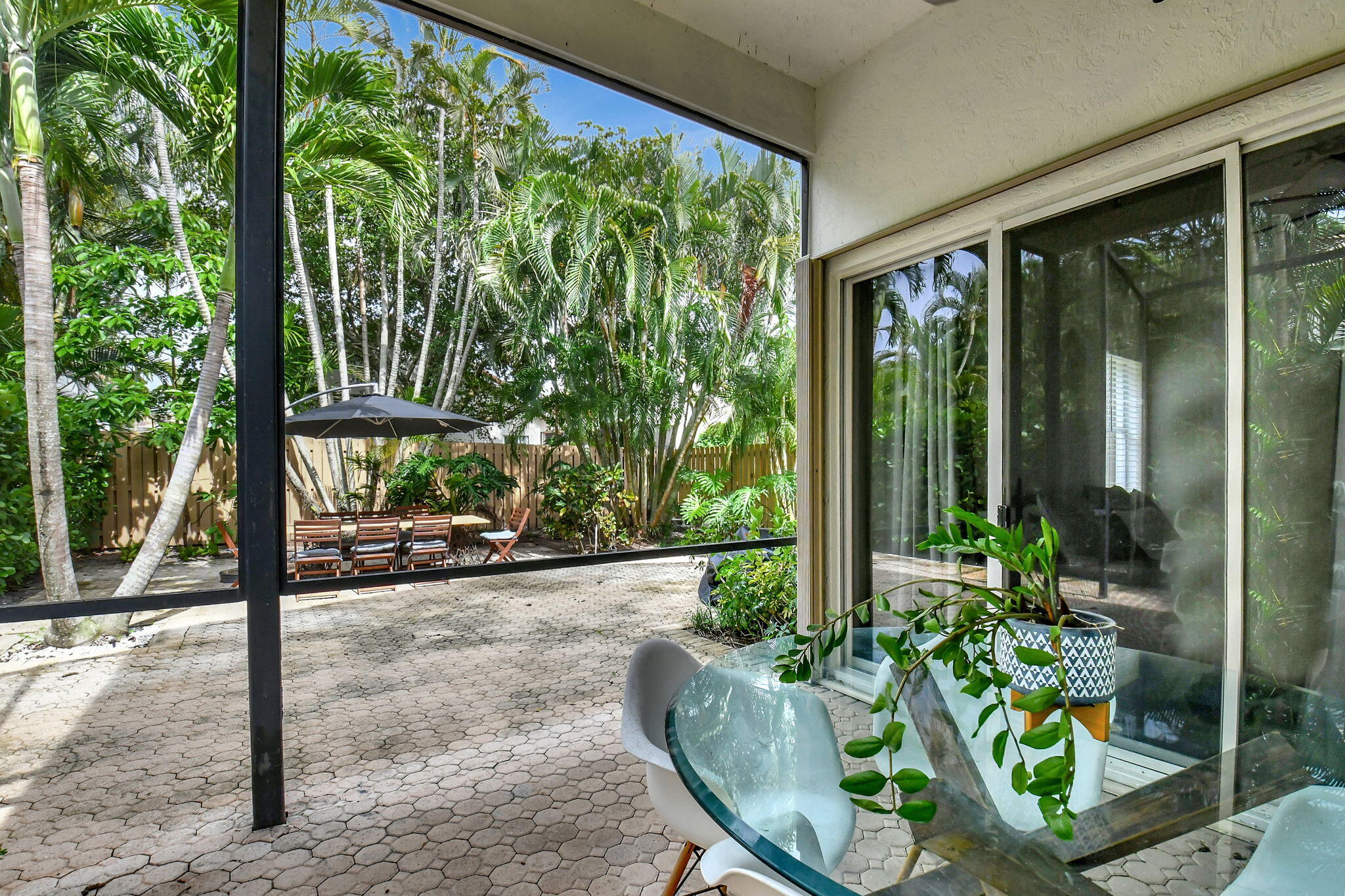 6623 Northwest 25th Avenue Boca Raton, FL 33496 - Photo 25 of 37 a view of a porch with chairs and floor to ceiling window