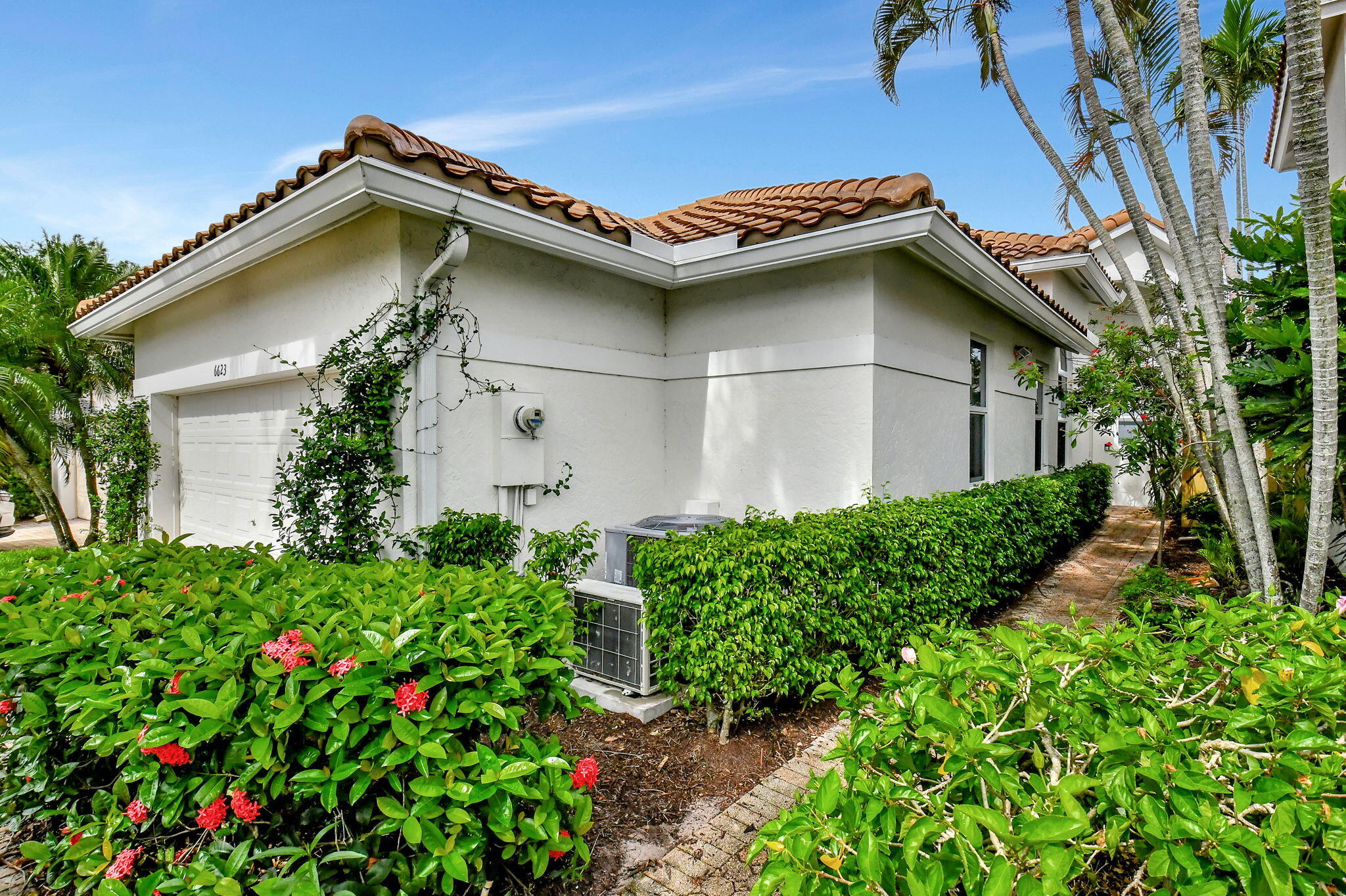 6623 Northwest 25th Avenue Boca Raton, FL 33496 - Photo 3 of 37 a front view of a house with garden