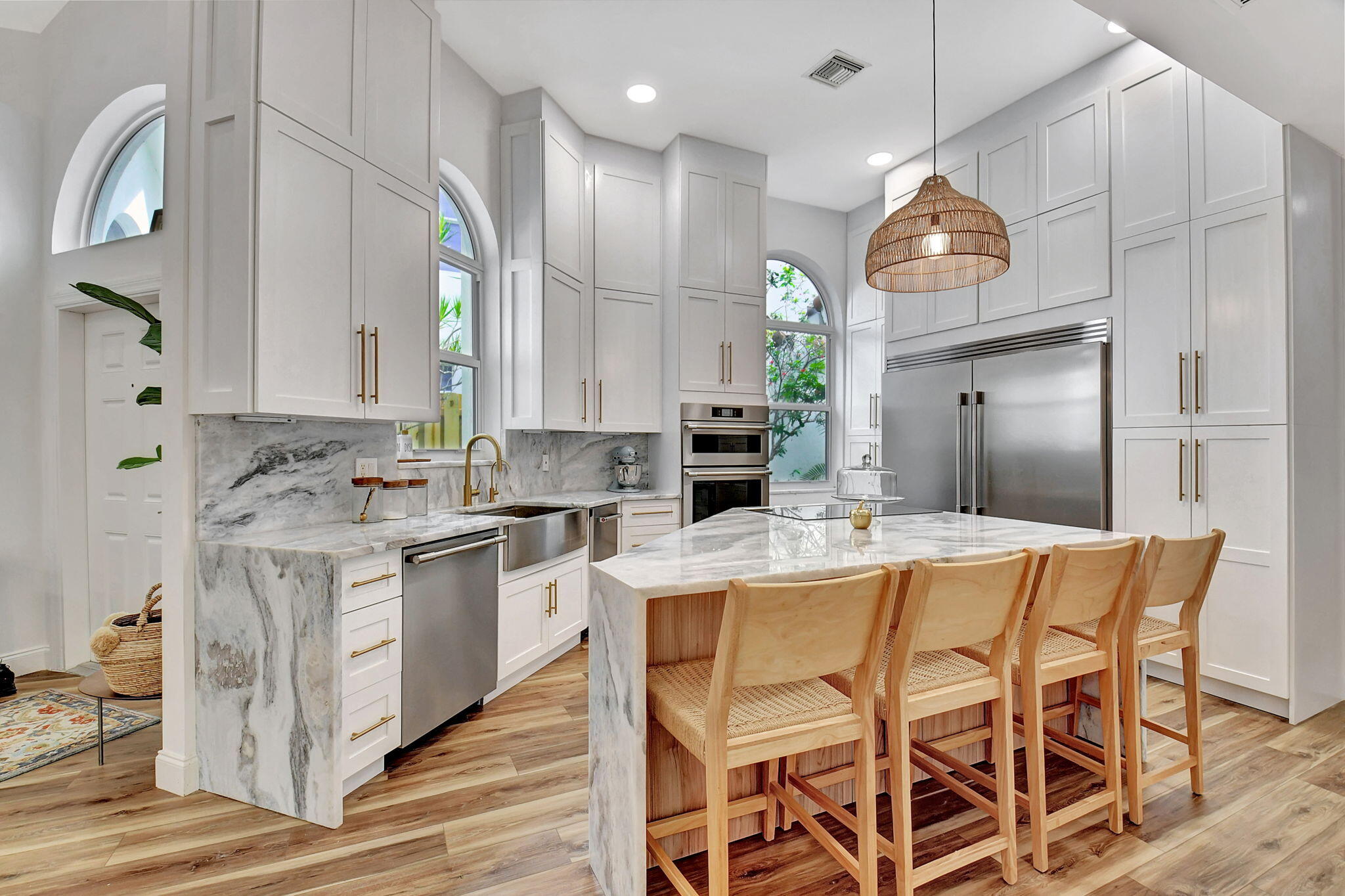 6623 Northwest 25th Avenue Boca Raton, FL 33496 - Photo 4 of 37 a kitchen with stainless steel appliances kitchen island granite countertop a stove a sink and a refrigerator