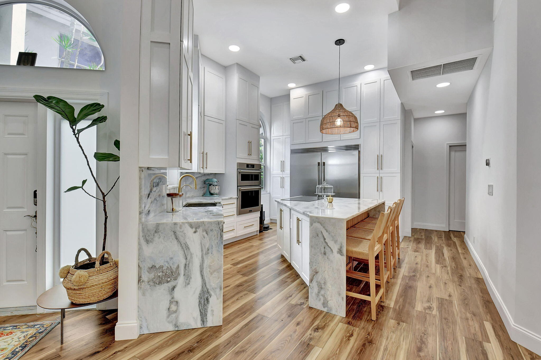 6623 Northwest 25th Avenue Boca Raton, FL 33496 - Photo 10 of 37 a open kitchen with cabinets a sink and wooden floor
