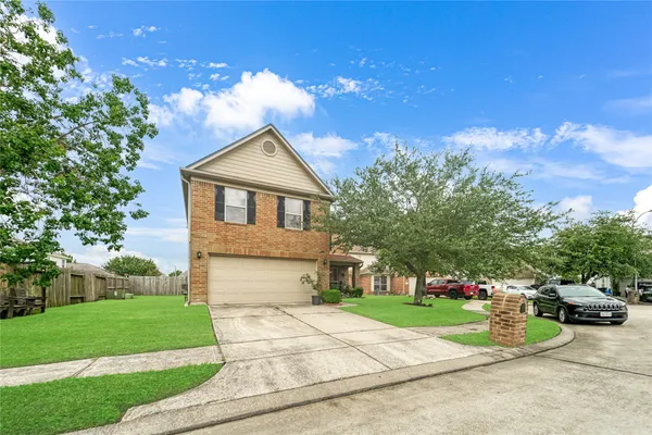 a front view of a house with a garden and yard