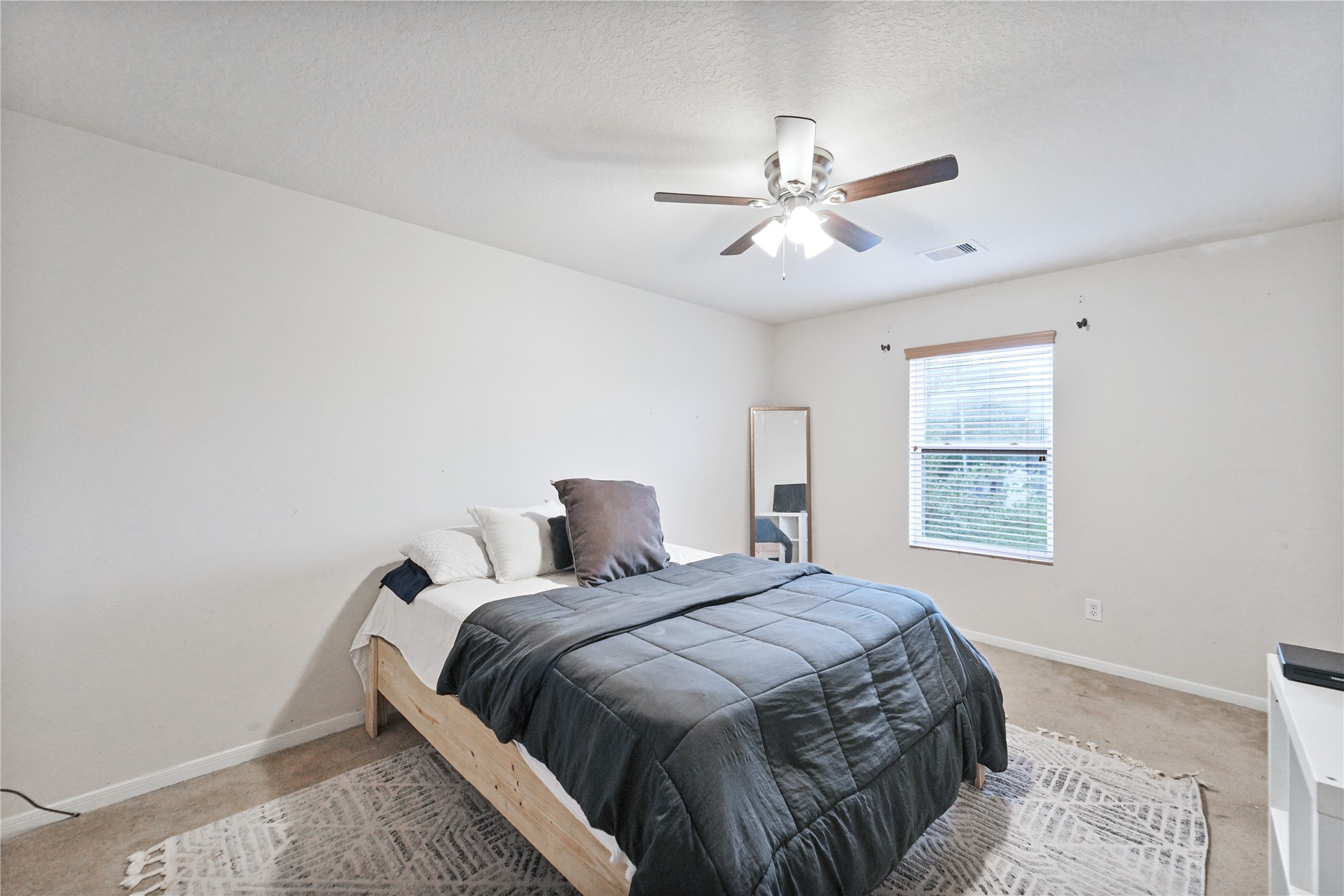 8011 Sumal Circle Baytown, TX 77521 - Photo 24 of 37 a bed sitting in a bedroom next to a window