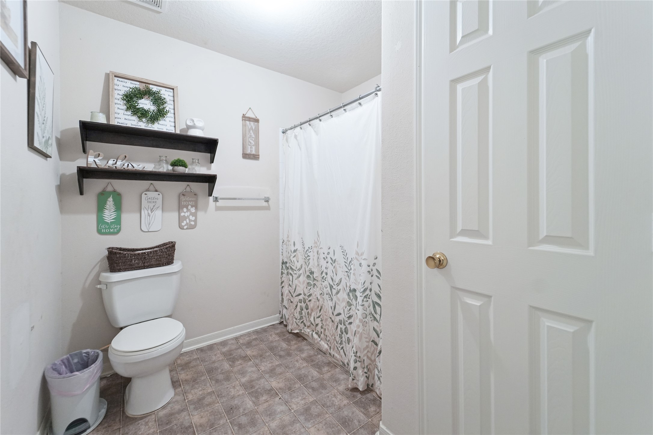 8011 Sumal Circle Baytown, TX 77521 - Photo 27 of 37 a bathroom with a toilet and a shower curtain