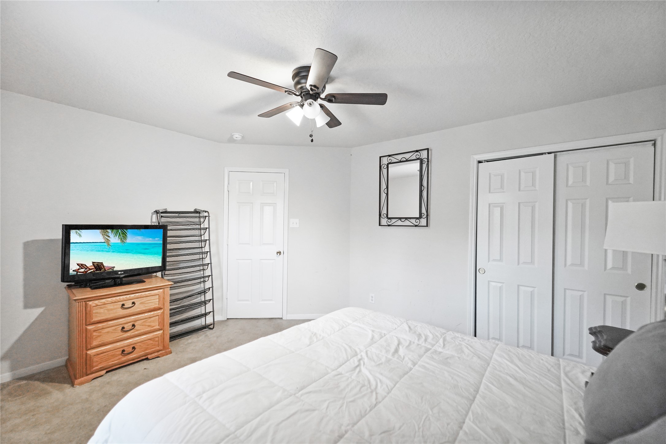 8011 Sumal Circle Baytown, TX 77521 - Photo 29 of 37 a bedroom with a bed and a flat screen tv