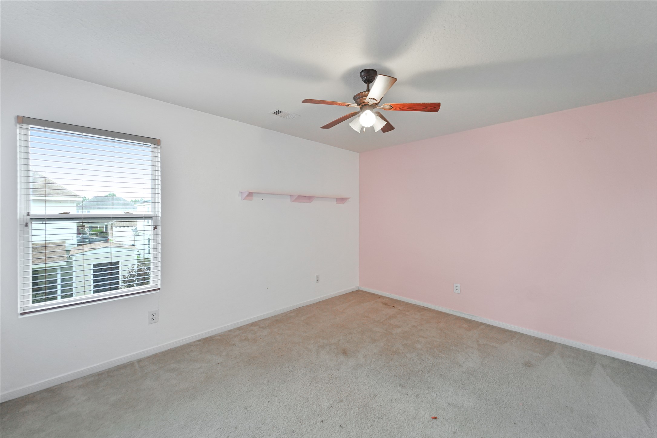 8011 Sumal Circle Baytown, TX 77521 - Photo 31 of 37 an empty room with a window and a ceiling fan