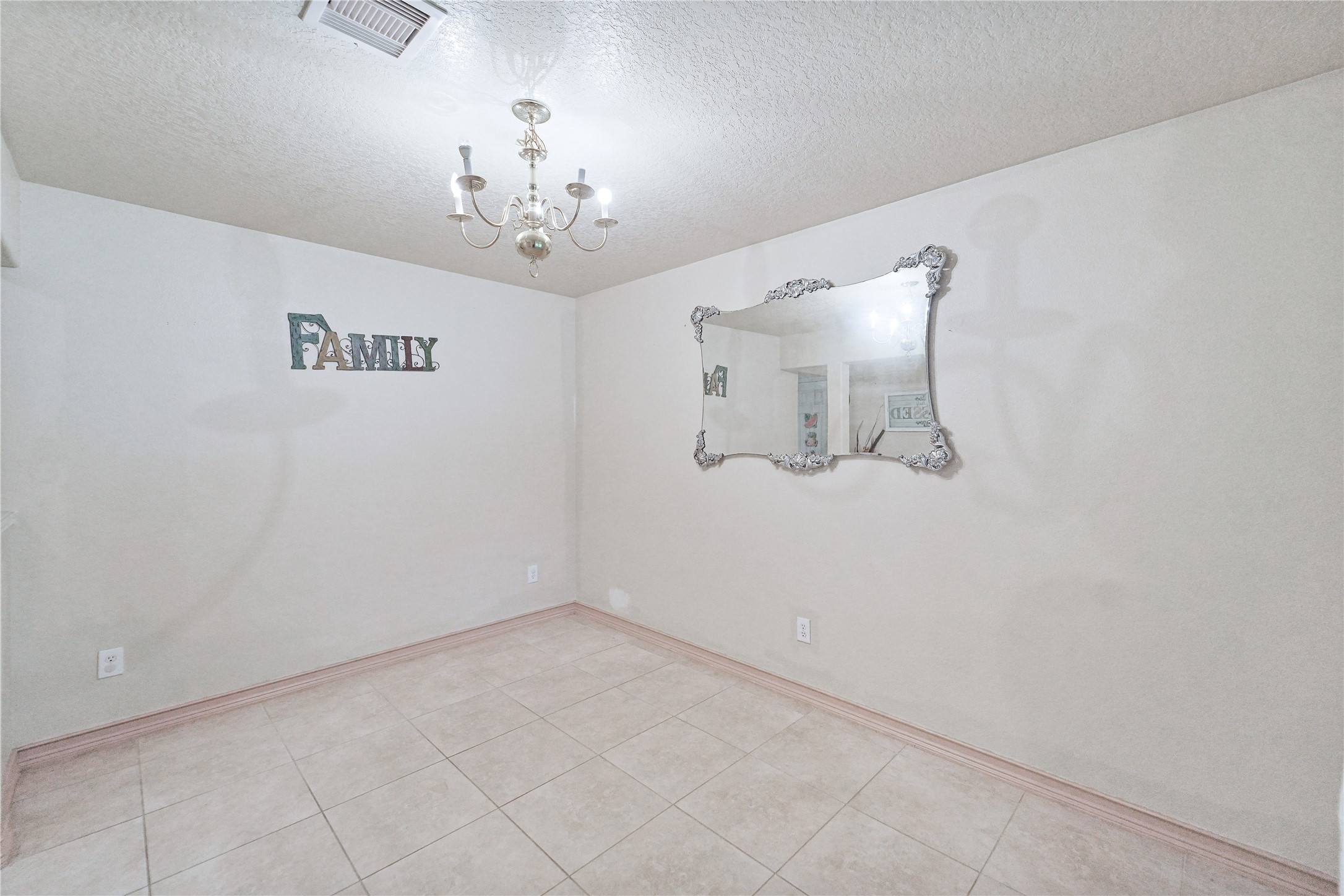 8011 Sumal Circle Baytown, TX 77521 - Photo 4 of 37 en empty room with a chandelier fan and windows