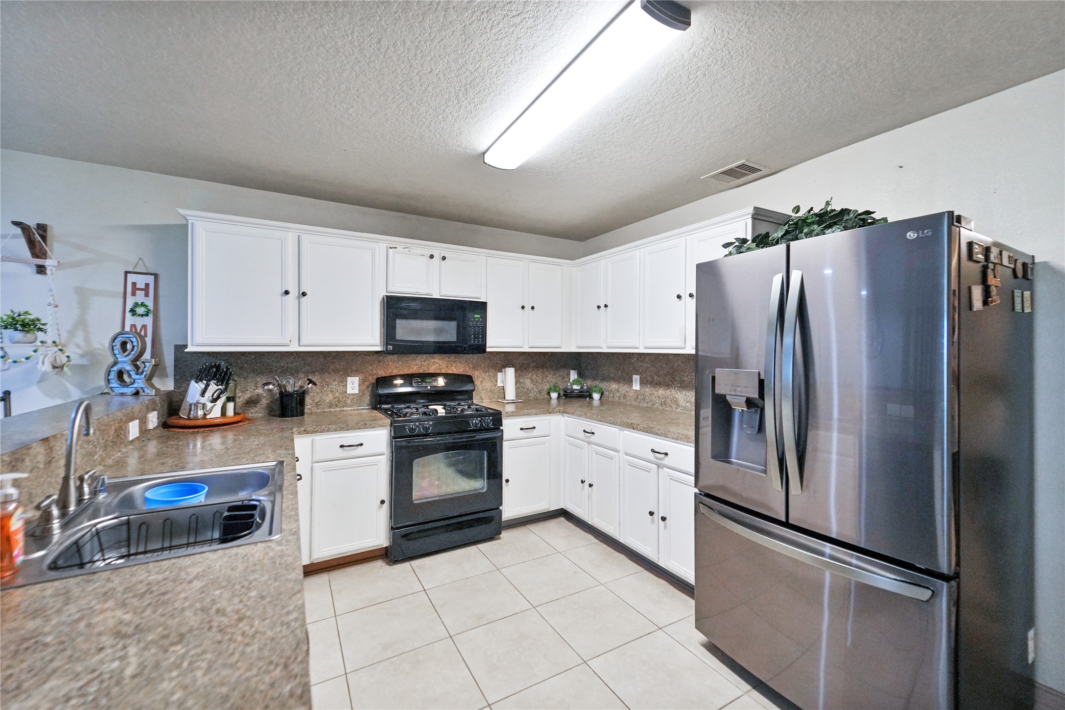 8011 Sumal Circle Baytown, TX 77521 - Photo 5 of 37 a kitchen with stainless steel appliances granite countertop a refrigerator sink and stove