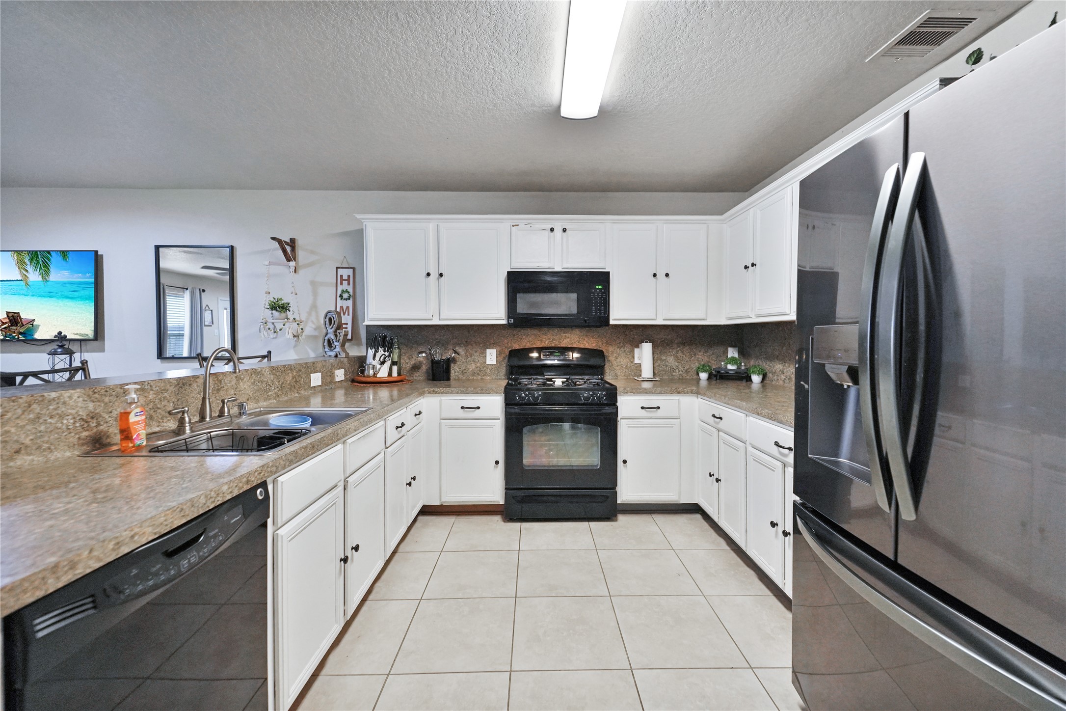 8011 Sumal Circle Baytown, TX 77521 - Photo 7 of 37 a kitchen with stainless steel appliances granite countertop a refrigerator sink and cabinets