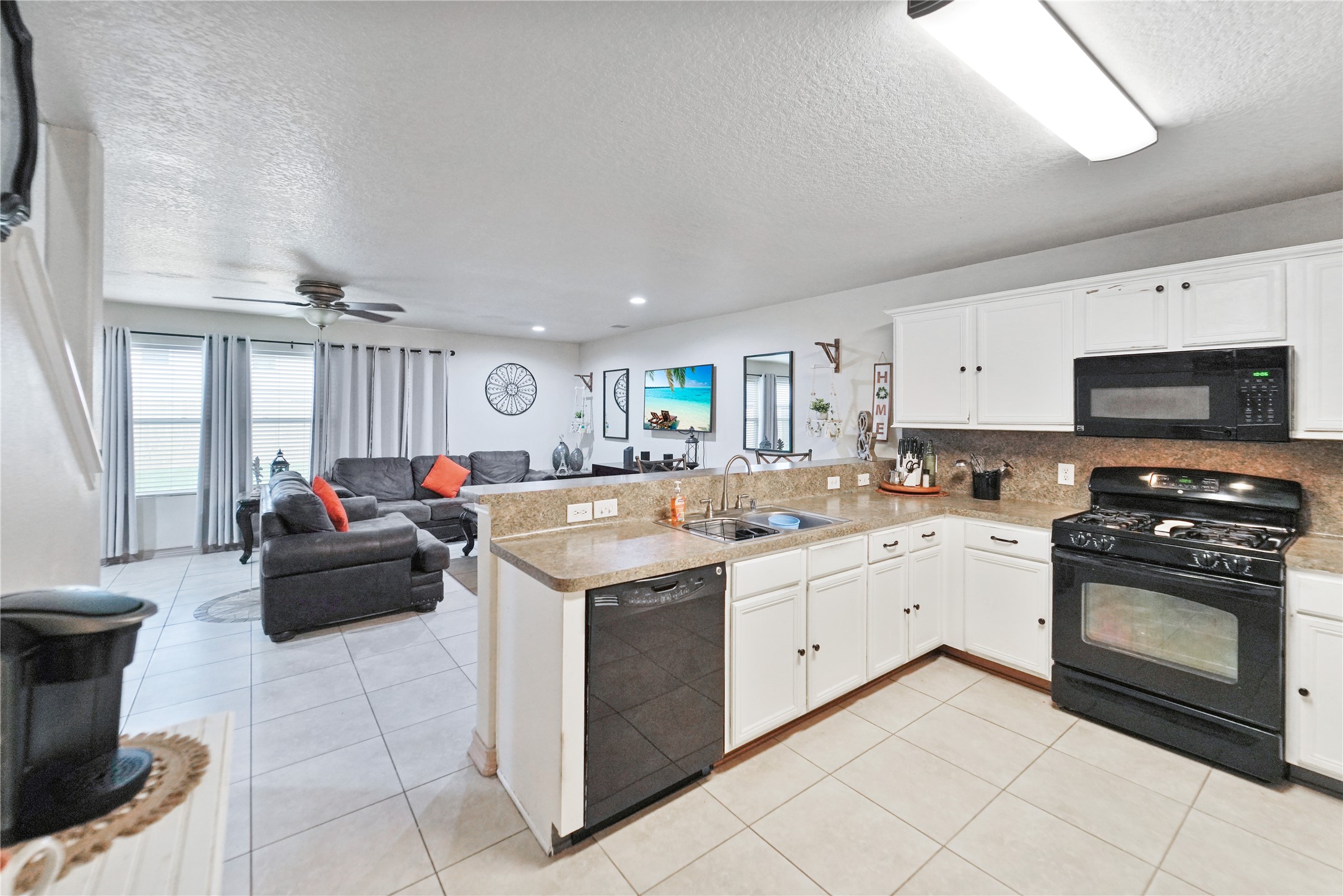 8011 Sumal Circle Baytown, TX 77521 - Photo 8 of 37 a kitchen that has a sink and a stove top oven
