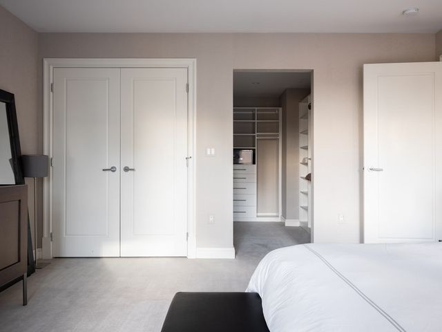 a bedroom with a bed and a flat tv screen